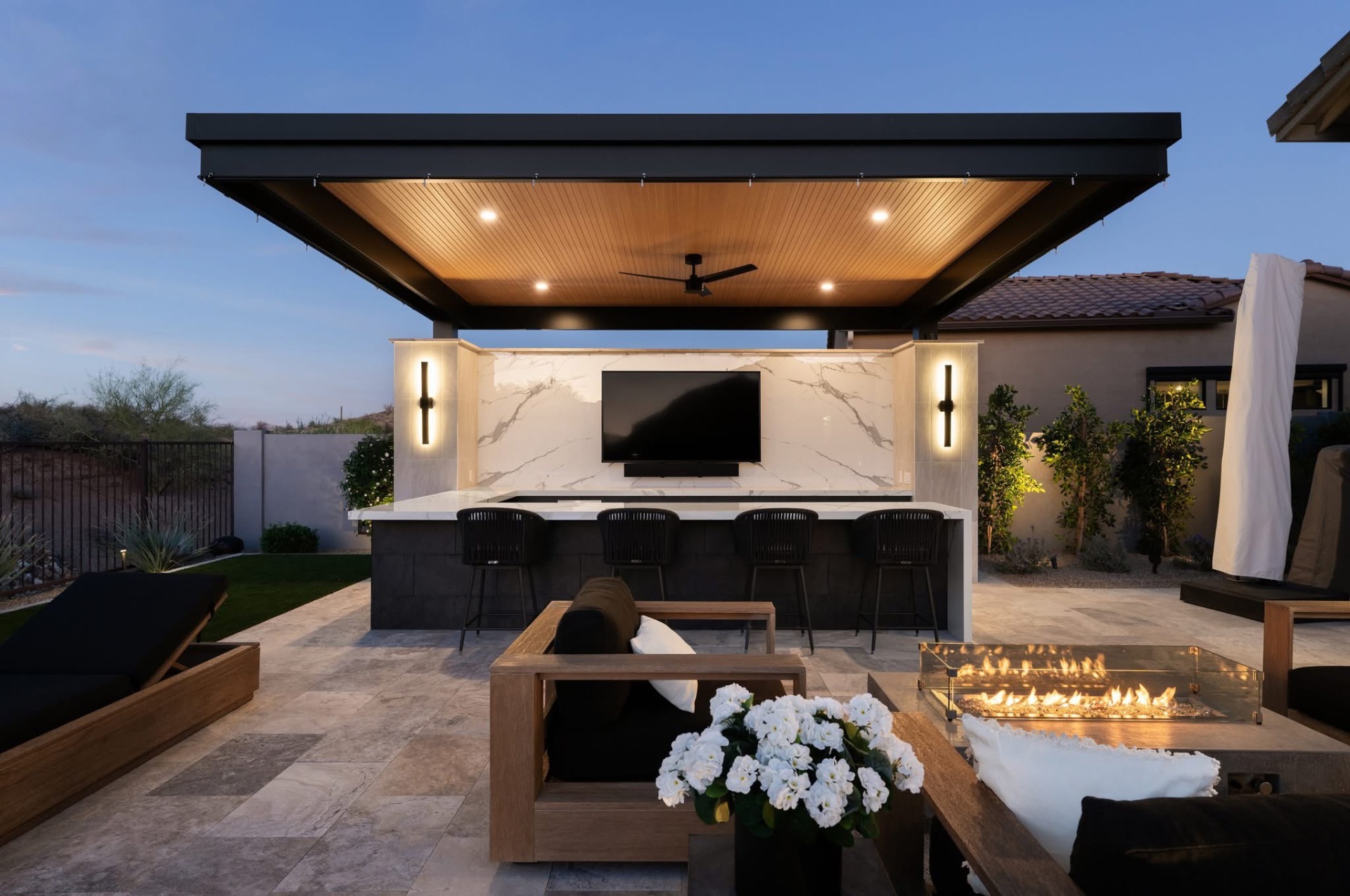 Custom aluminum pergola over outdoor living space with bar, TV, fire pit and seating